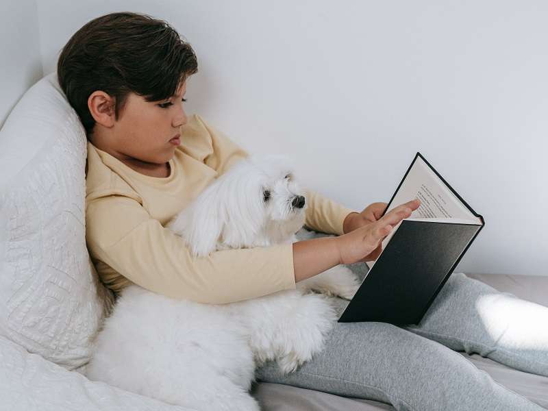 kid reading to pet selfhelptech